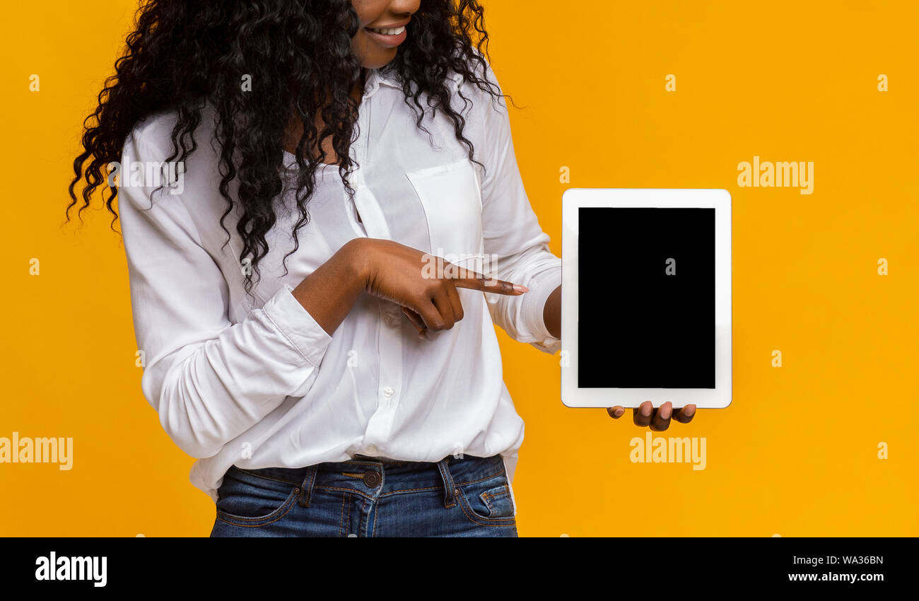 Black lady pointing at blank digital tablet screen Stock Photo - Alamy
