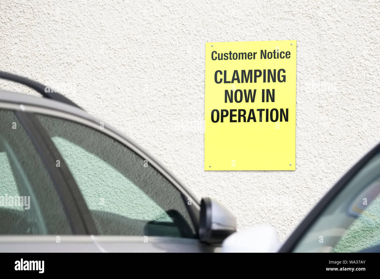 Car clamping notice sign in public park private road Stock Photo Alamy