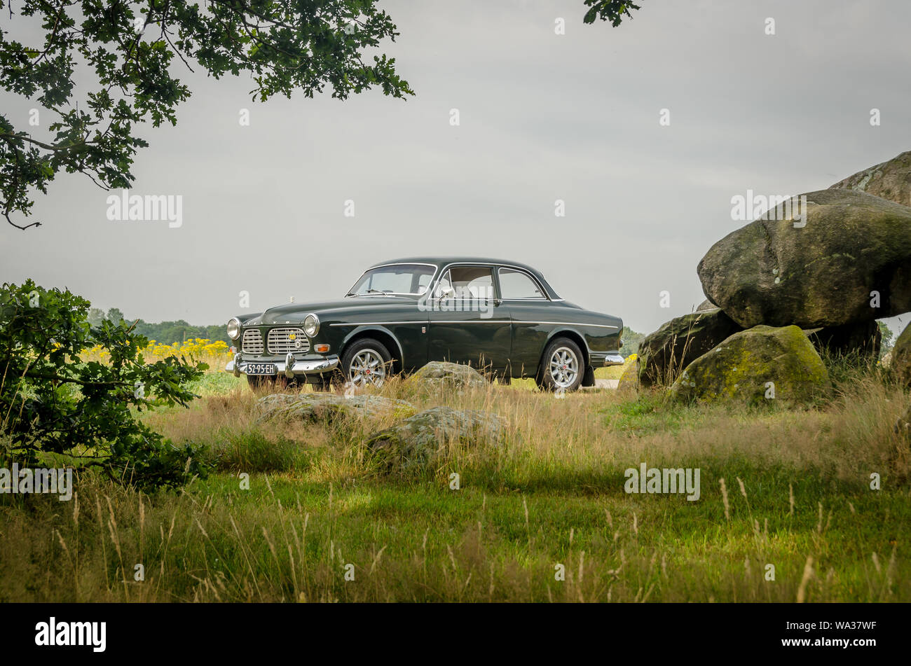 Loon, Holland - july 12 2019: .Volvo Amazon classic 1960s Sweden retro car pictured on the road. Standing near the dutch 'hunnebed' . The Hunebed was Stock Photo