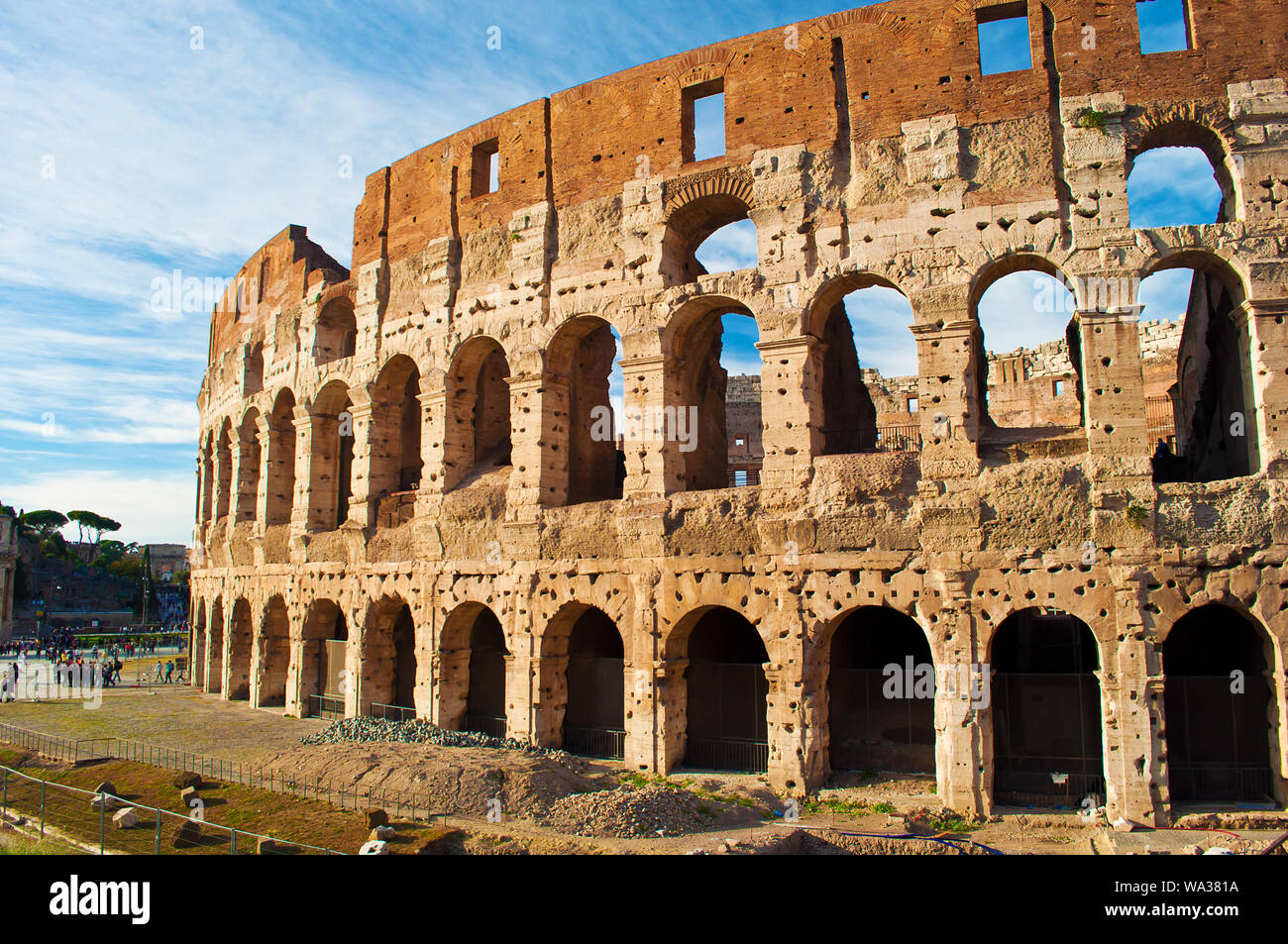 View of the amphitheater of Colosseum against blue sky with wispy