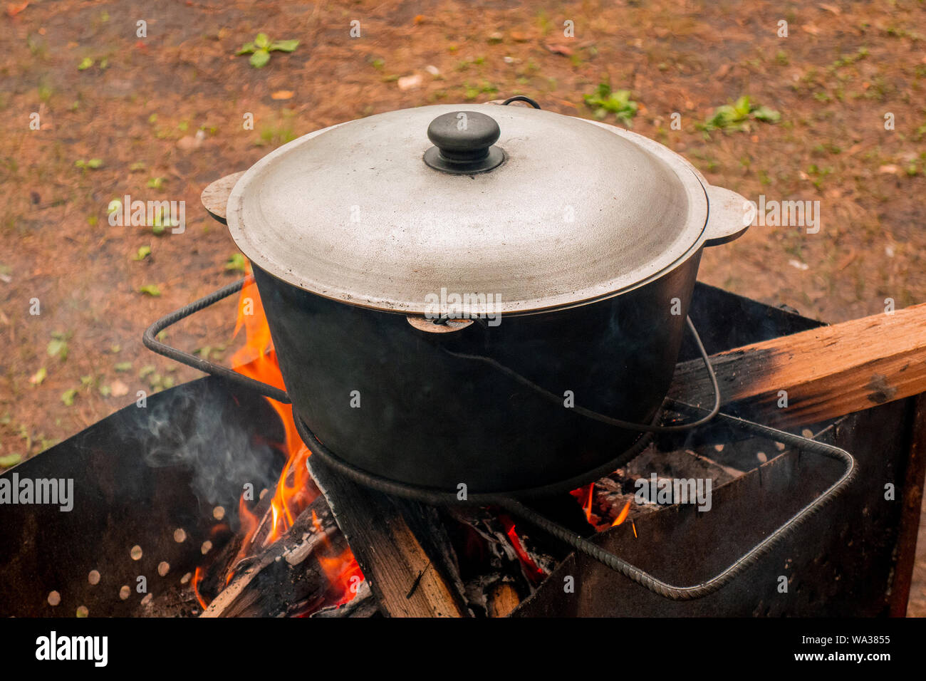 Cooking in a large pot, outside Stock Photo - Alamy