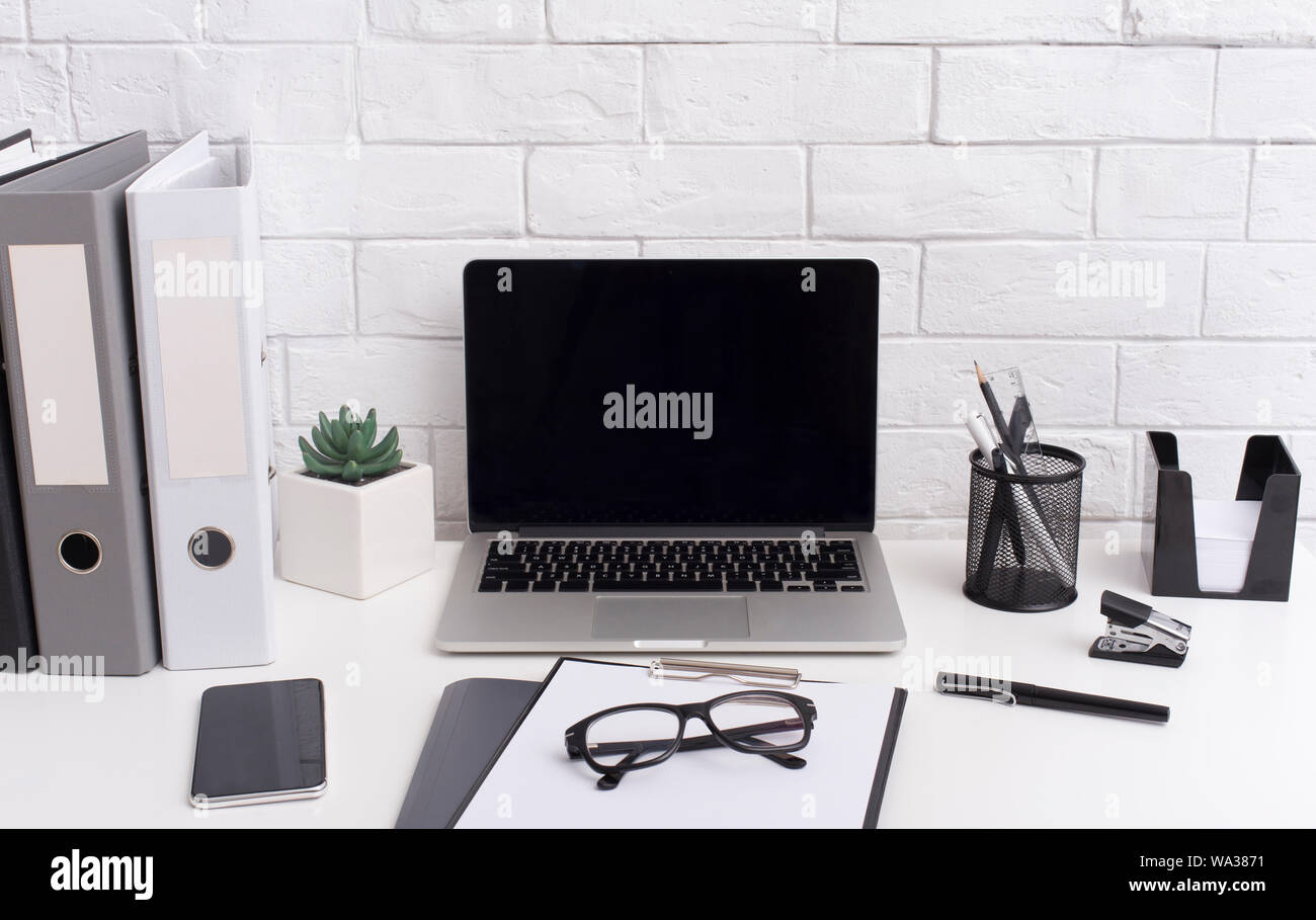 Modern laptop with blank screen and office stationery Stock Photo - Alamy