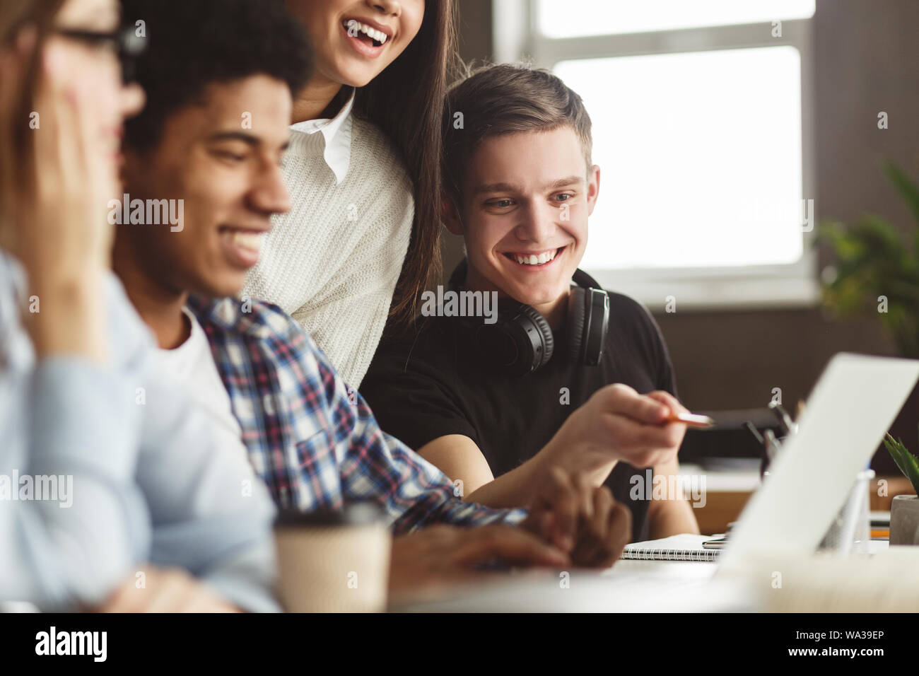 International students looking at laptop in school Stock Photo