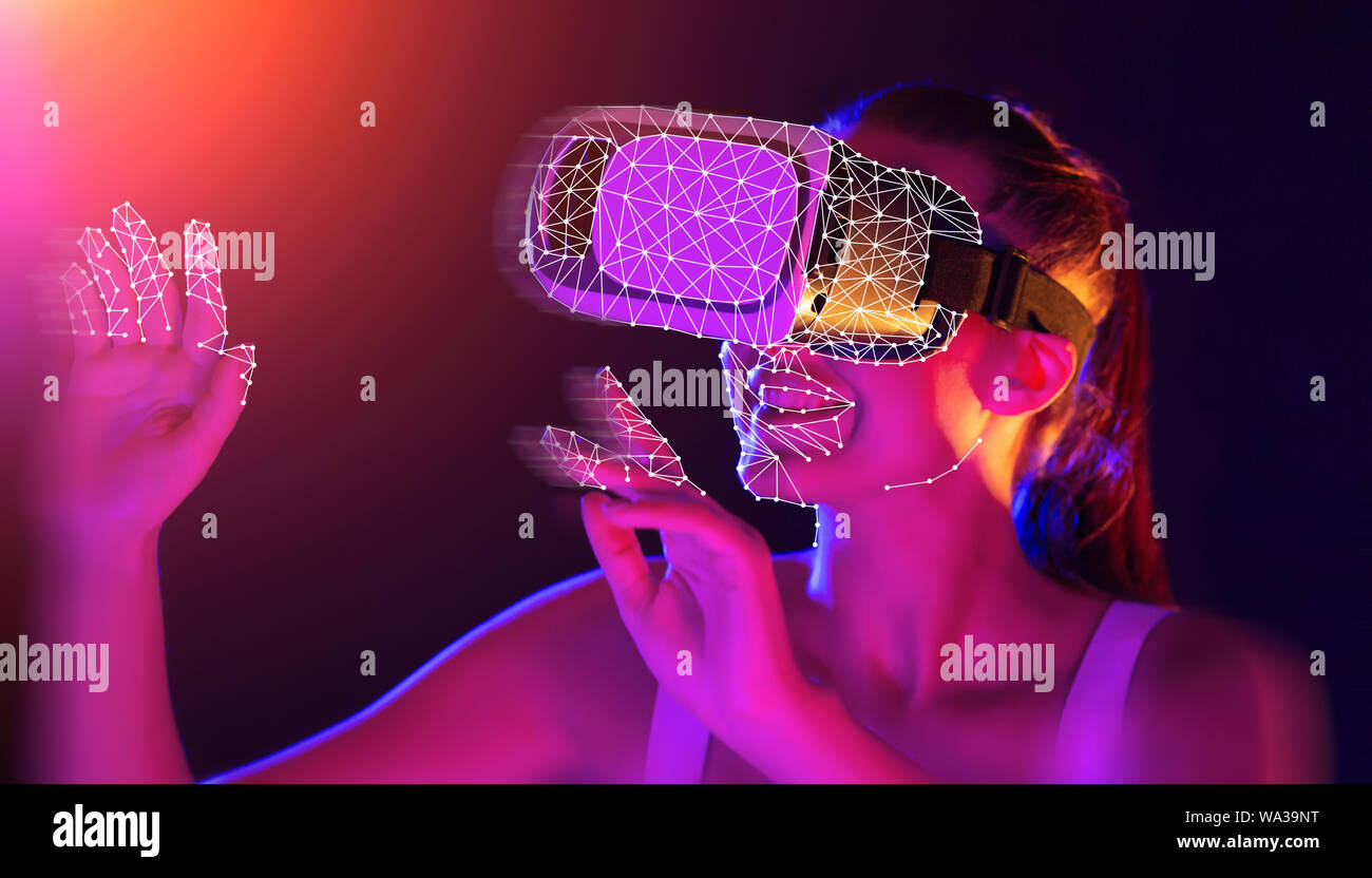 Young woman wearing VR headset using futuristic interface Stock Photo ...