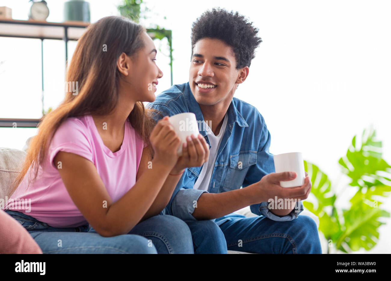 Couple of teenagers drinking coffee and chatting Stock Photo