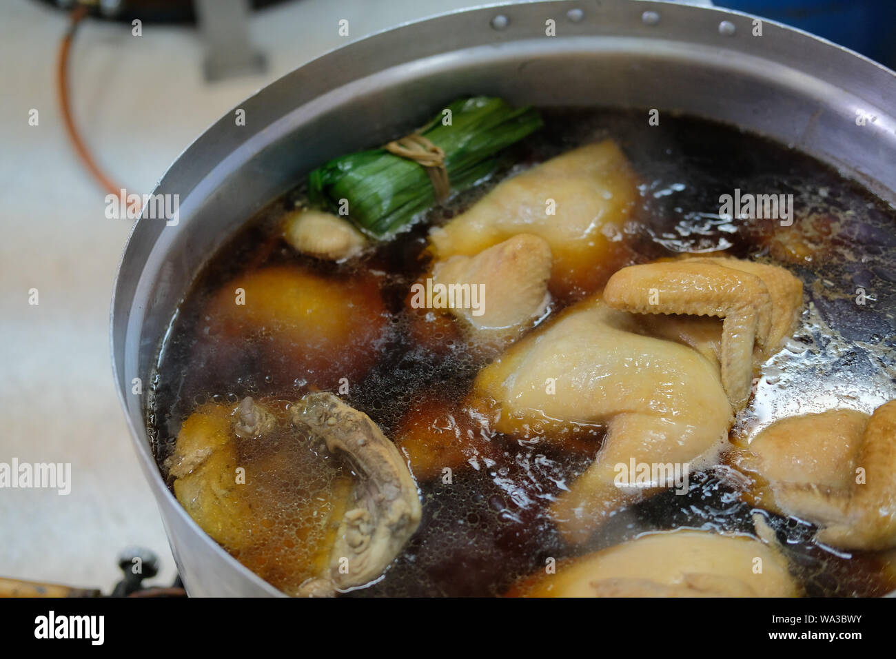 chicken boiling in fish sauce soup. boiled braised chicken Stock Photo