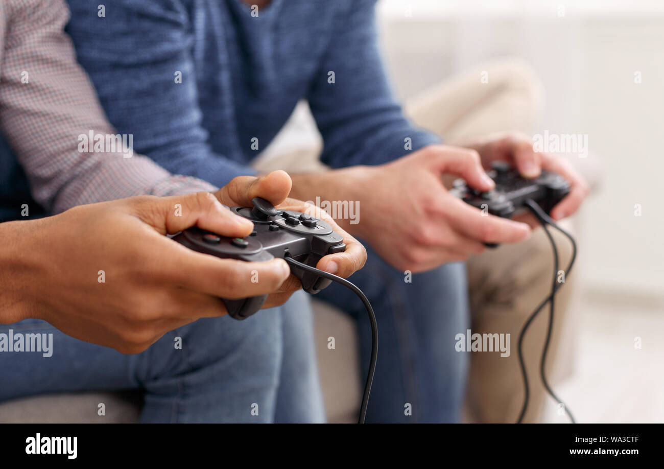 Male hands holding joysticks, playing video games Stock Photo Alamy
