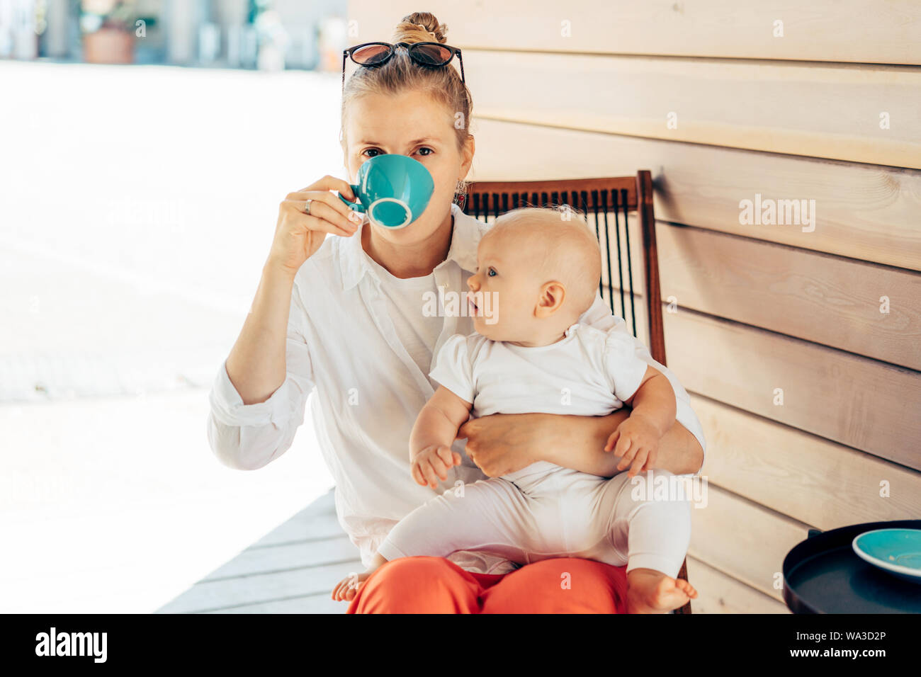woman with a child drinks coffee Stock Photo Alamy