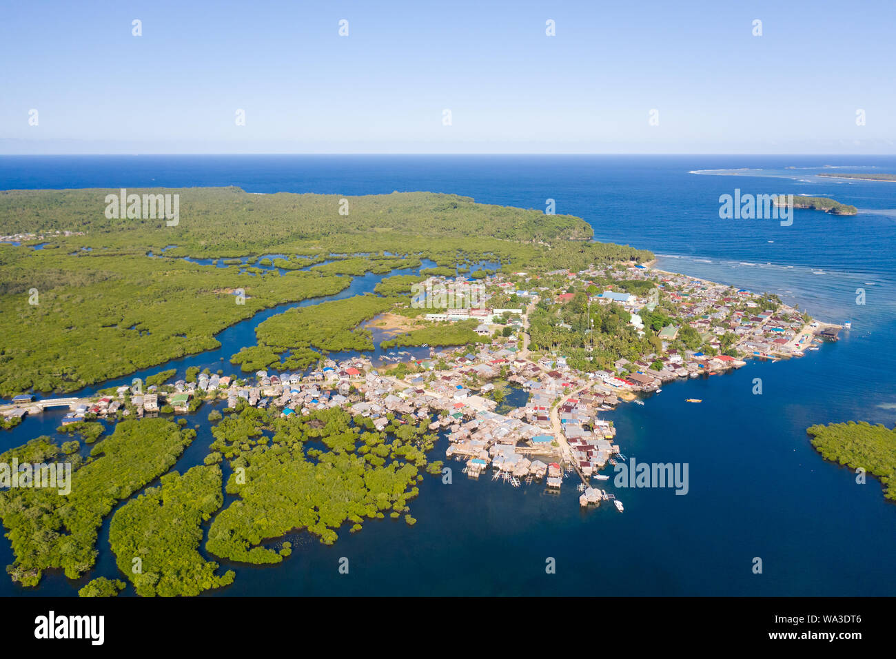 Town on the water and mangroves, top view. Coast of the island of Siargao. Tropical landscape. Stock Photo