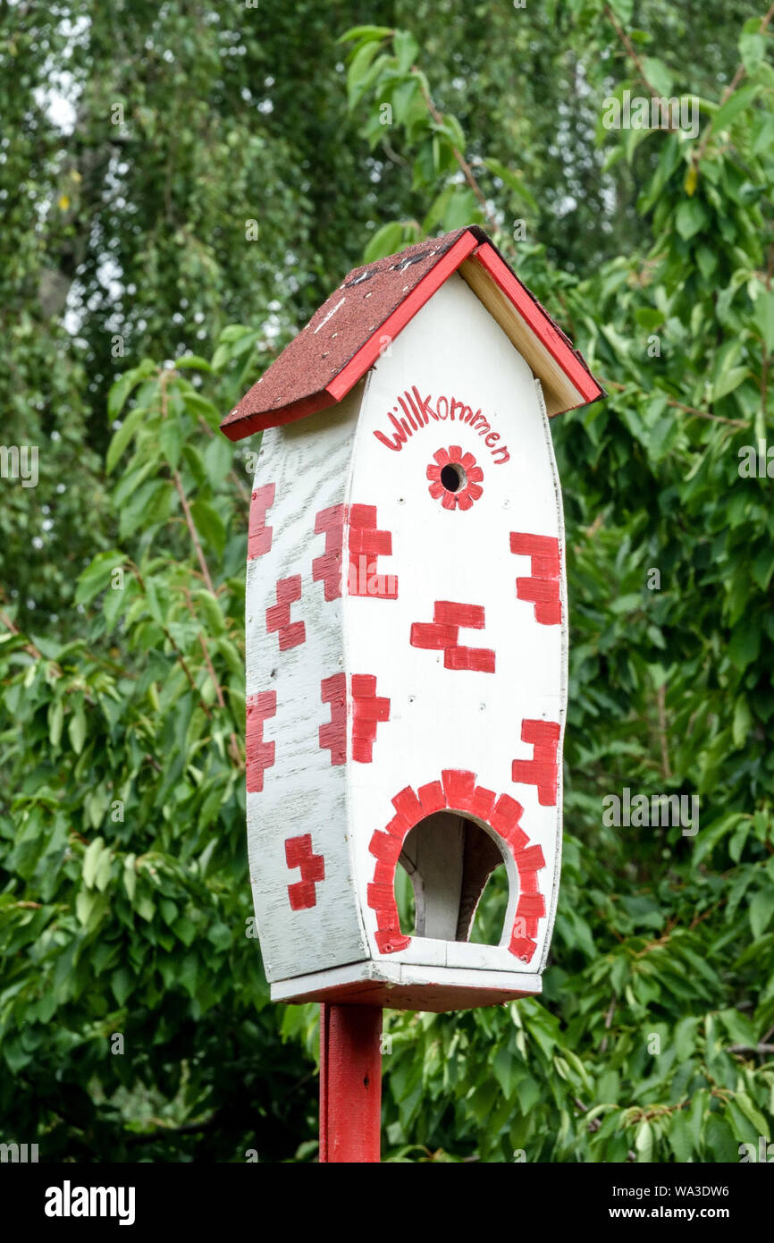 Red-white birdhouse in a German garden Stock Photo