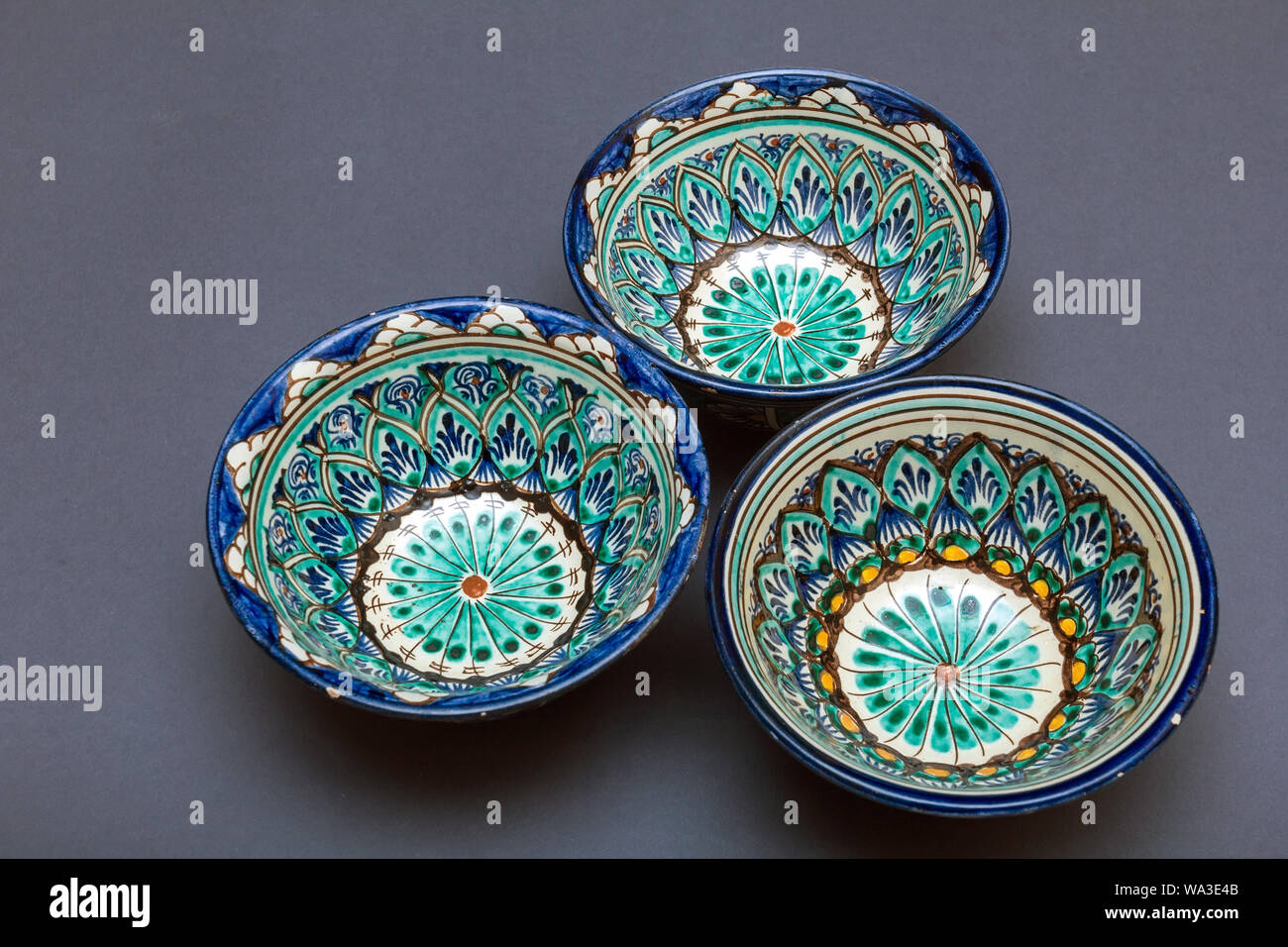 Ethnic Uzbek ceramic tableware on the gray background. Decorative ...