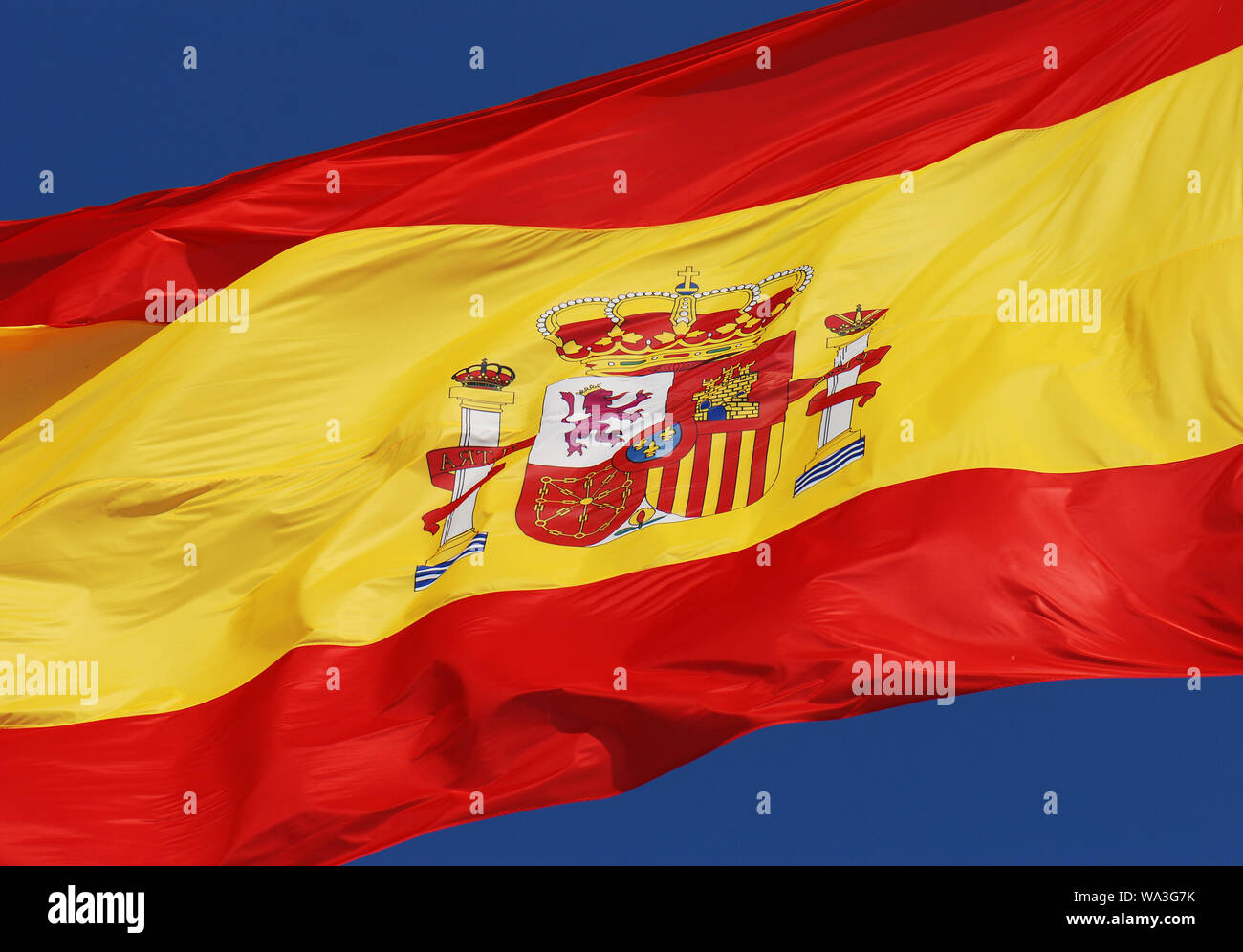 spanish flag under blue sky Stock Photo