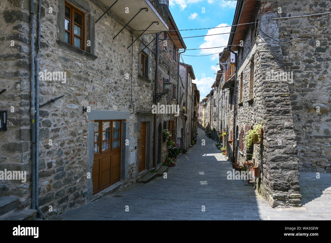 Narrow alley  with houses from field stones in Virgoletta, a beautiful ancient mountain village, district of Villafranca in Lunigiana, Tuscany, Italy Stock Photo