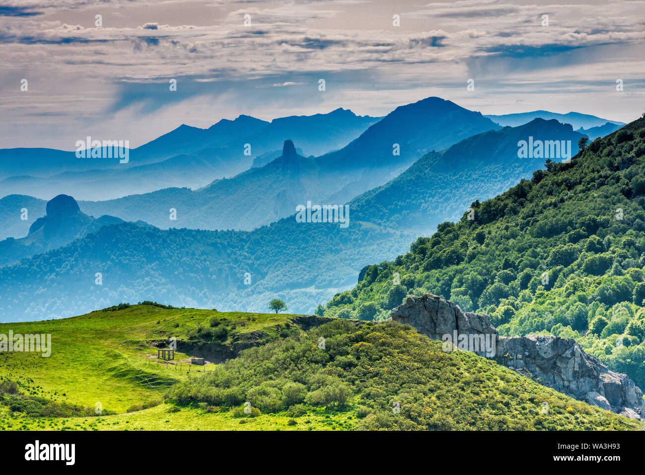 Cordillera Cantabrica distant mountain ranges, view from Mirador del Corzo on road N621 over Valle de Cereceda, Picos de Europa, Cantabria, Spain Stock Photo