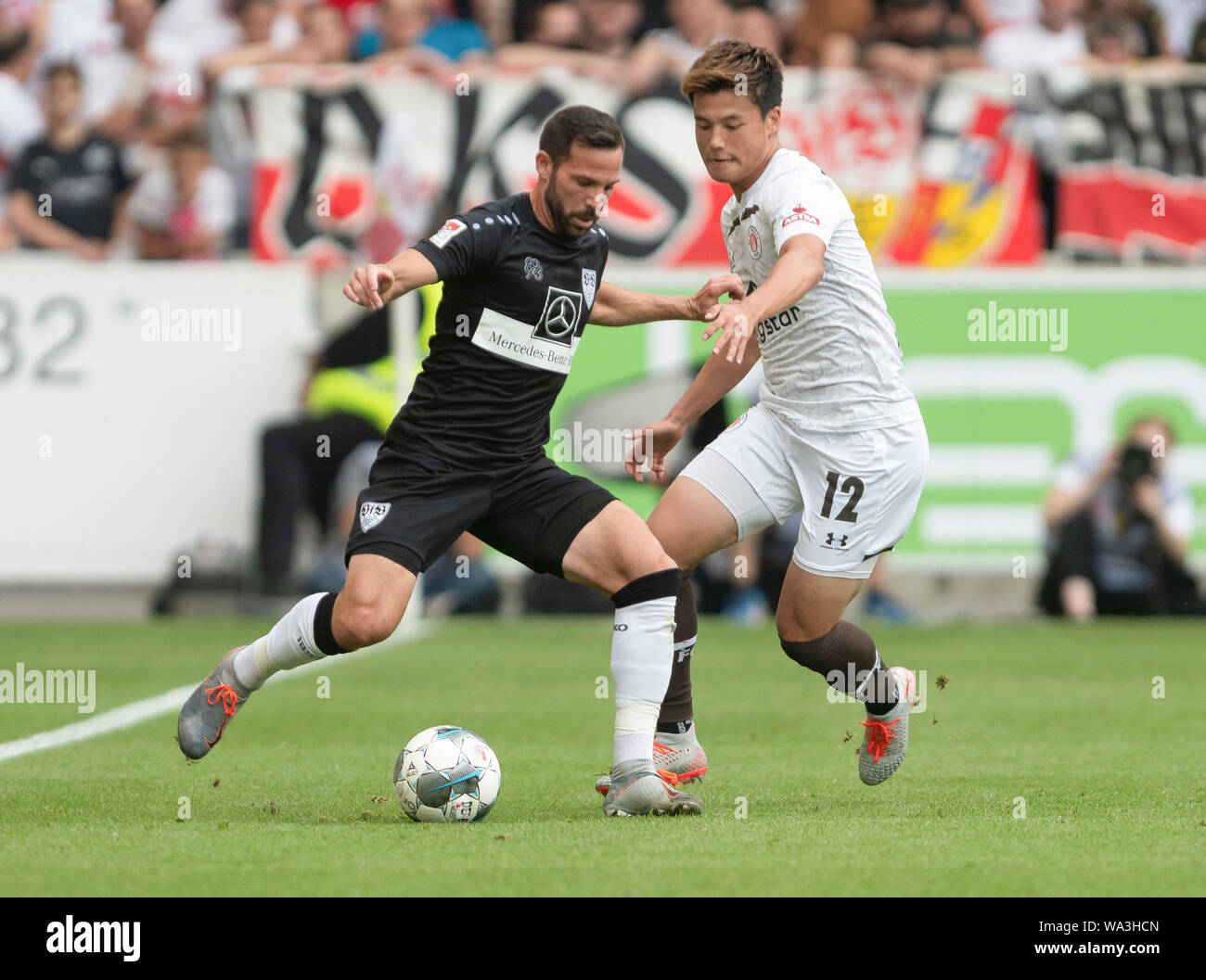 Stuttgart, Germany. 17th Aug, 2019. Soccer: 2nd Bundesliga, VfB Stuttgart - FC St. Pauli, 3rd matchday. Stuttgart's Gonzalo Castro (l) plays the ball in front of St. Paulis Ryo Miyaichi. Credit: Daniel Maurer/dpa - IMPORTANT NOTE: In accordance with the requirements of the DFL Deutsche Fußball Liga or the DFB Deutscher Fußball-Bund, it is prohibited to use or have used photographs taken in the stadium and/or the match in the form of sequence images and/or video-like photo sequences./dpa/Alamy Live News Stock Photo