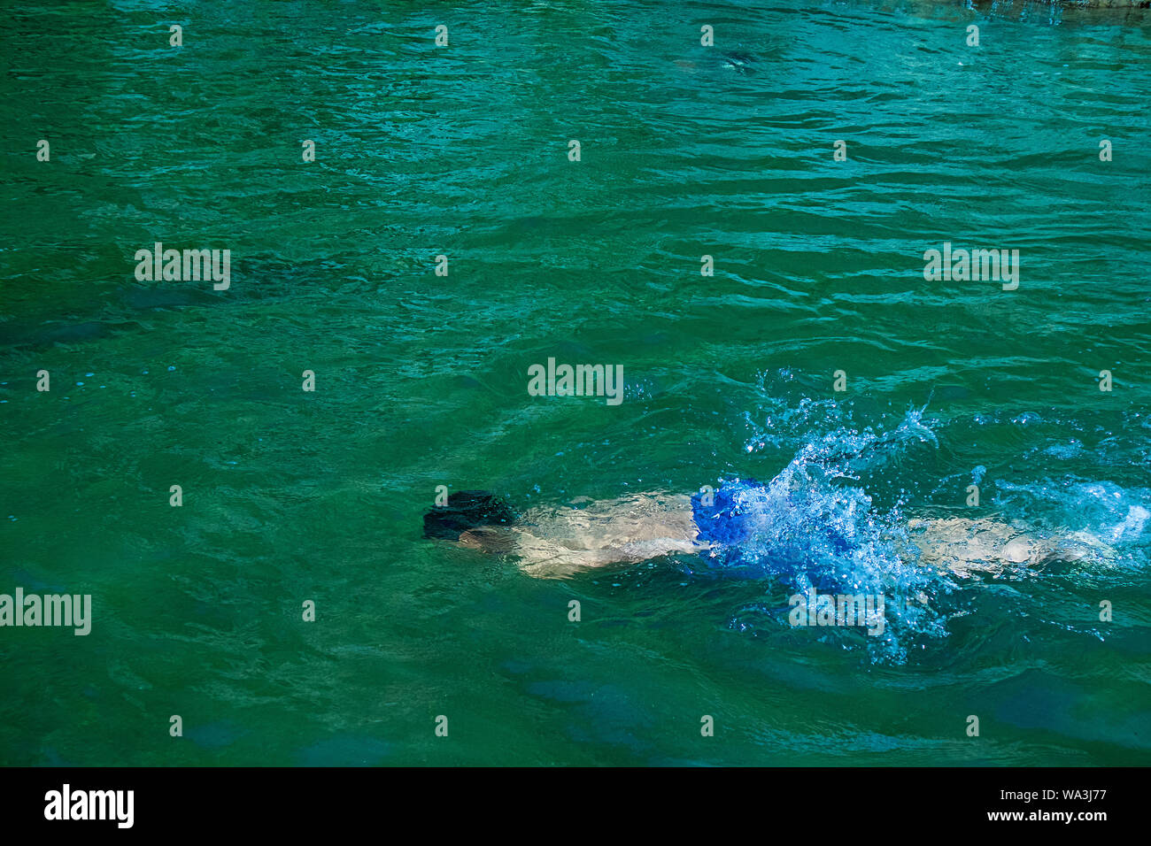 Young boy drowning in to the water, failure and rescue concept Stock