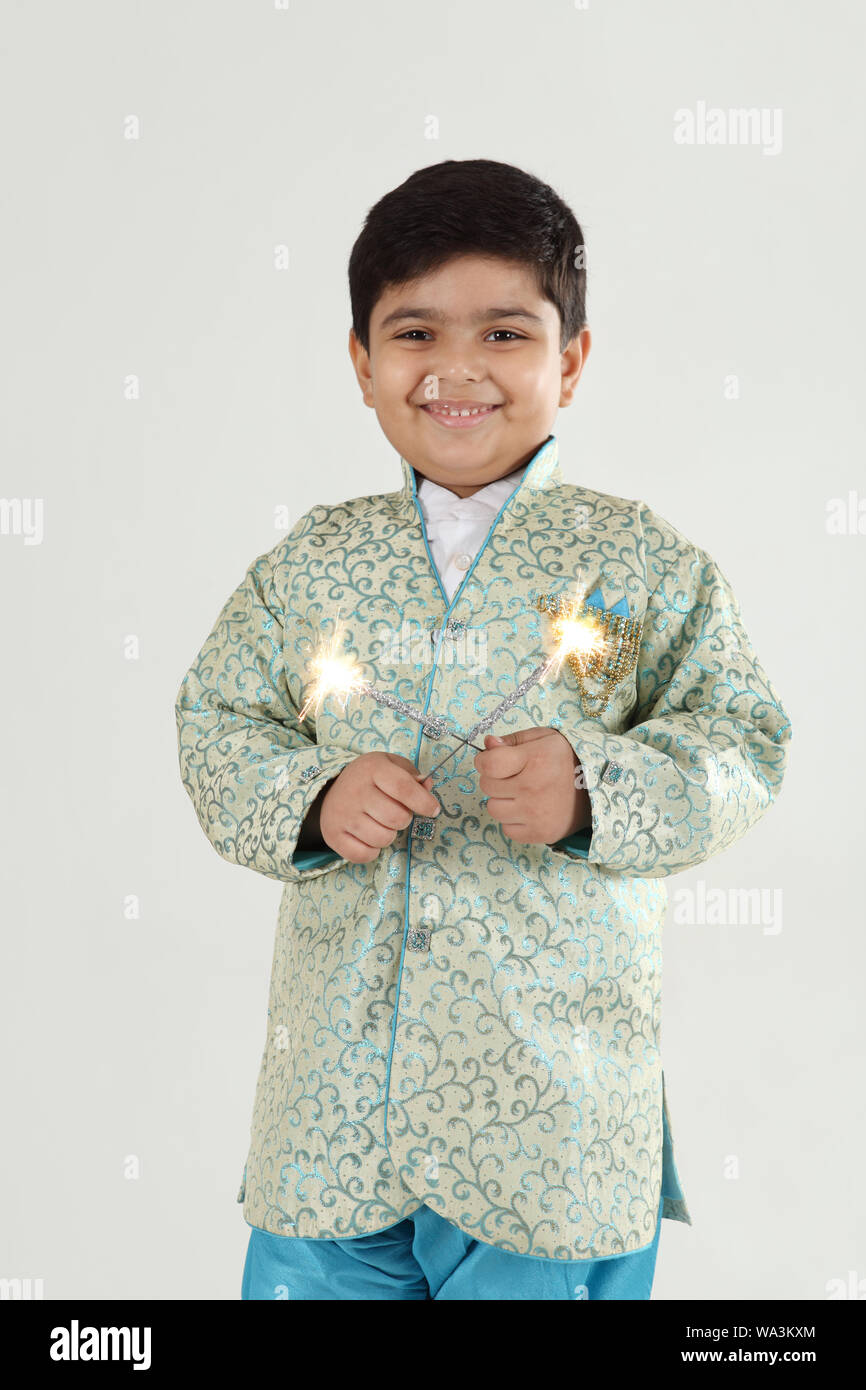 Boy burning phooljhadi on Diwali Stock Photo