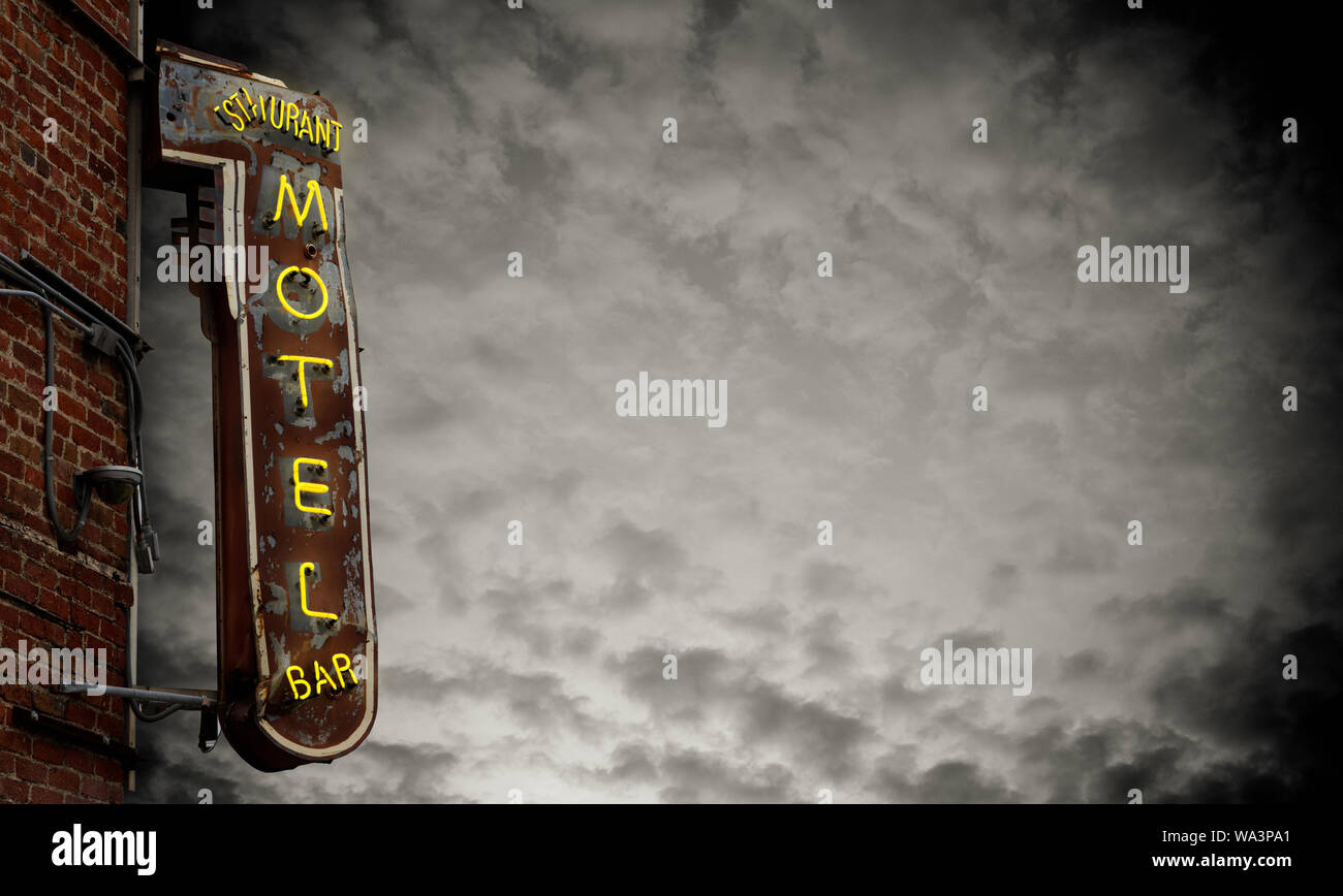 A Grungy Old Neon Motel Sign Against A Stormy Sky With Copy Space Stock Photo