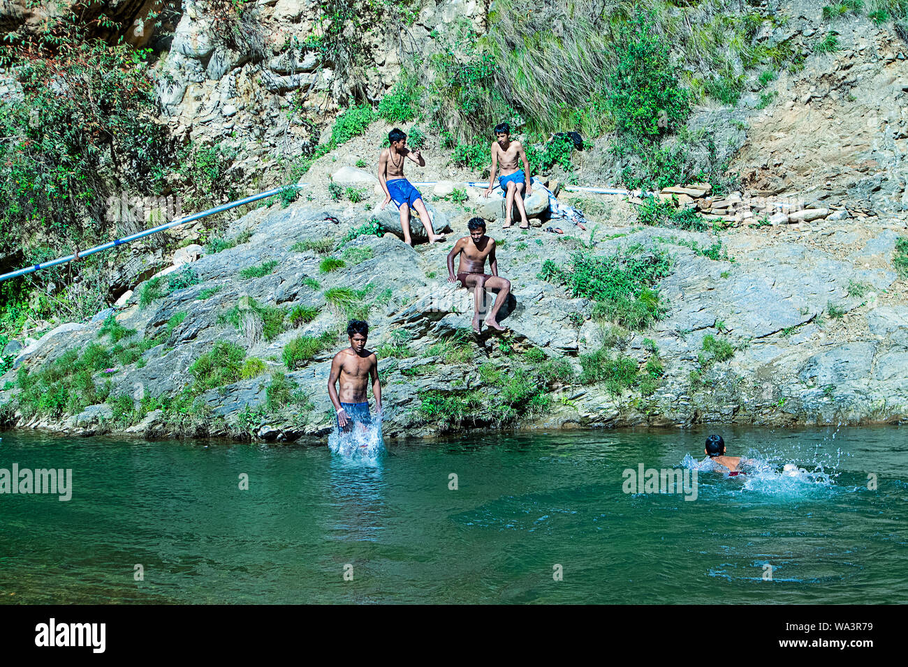 Nehrwa, Himachal Pradesh, india - April 20th, 2019: Boys swimming in fresh river water on a summer vacations Stock Photo