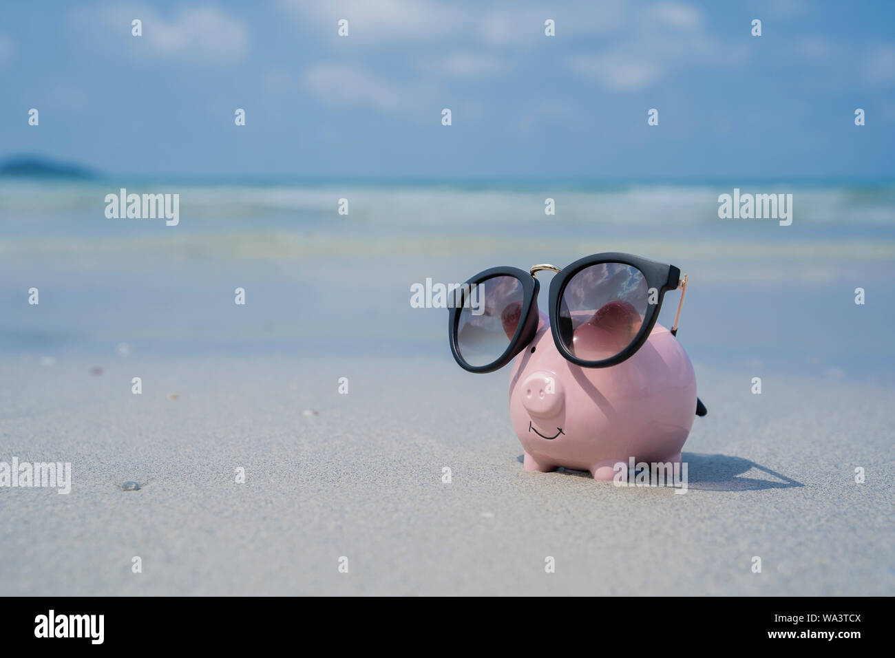 Pig piggy bank with sunglasses on the sand beach Stock Photo - Alamy