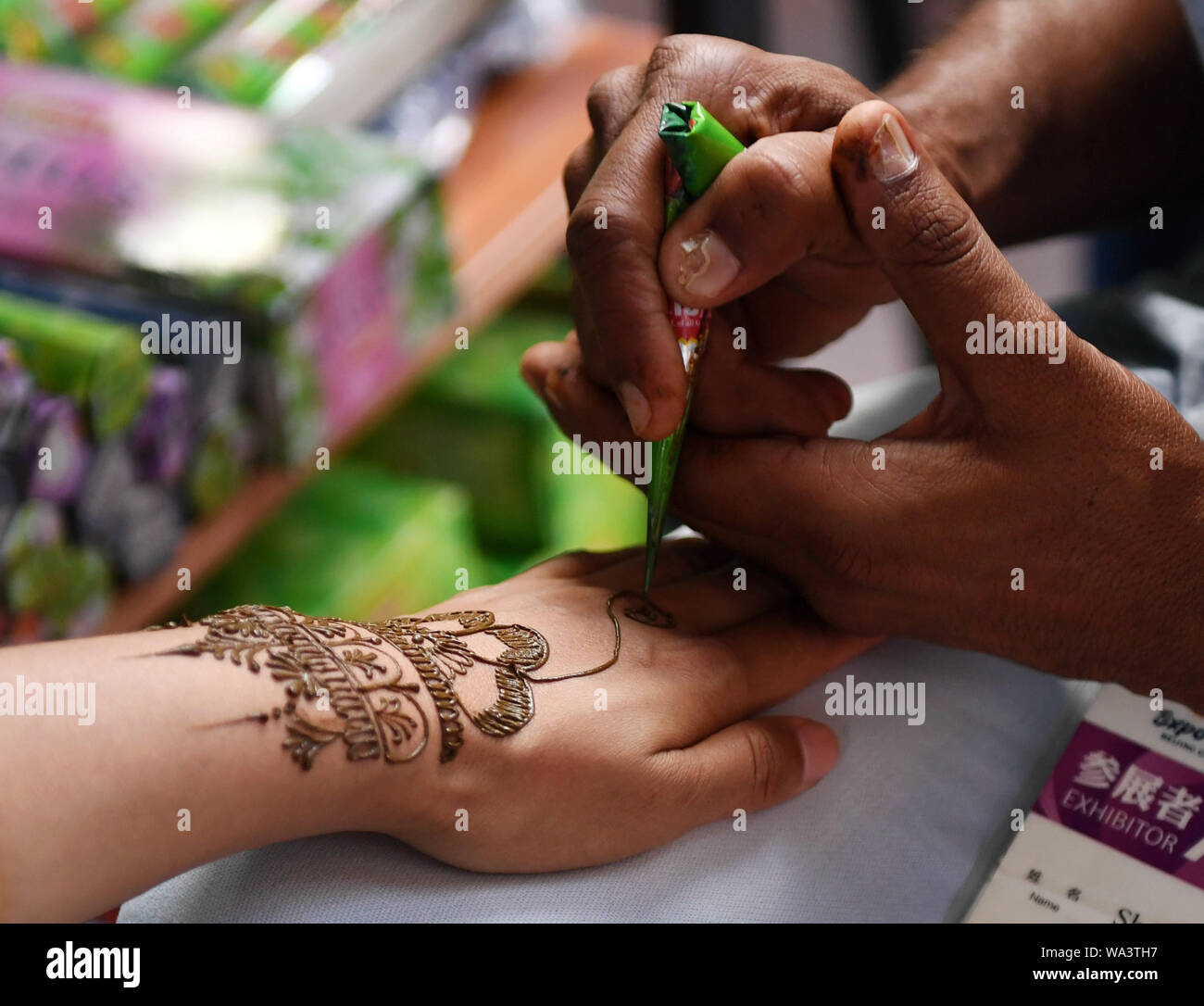 Beijing, China. 17th Aug, 2019. A tourist gets a Henna tattoo at the India Garden during the Beijing, China. 17th Aug, 2019. A tourist gets a Henna tattoo at the India Garden during the
