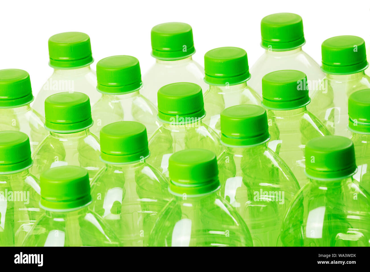 A collection of green plastic bottles isolated on a white background Stock Photo