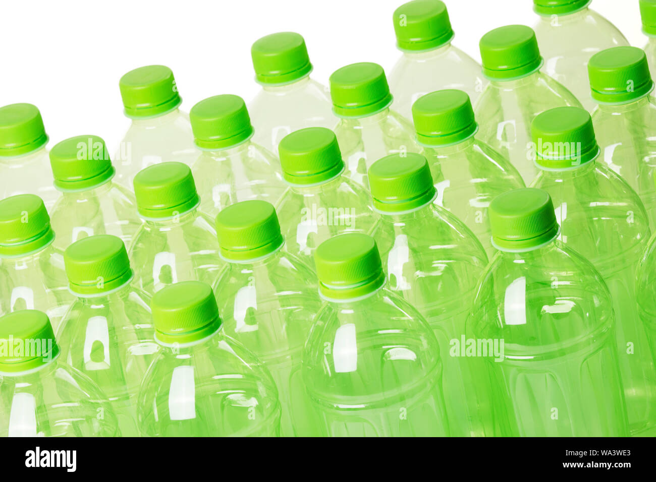 A collection of green plastic bottles isolated on a white background