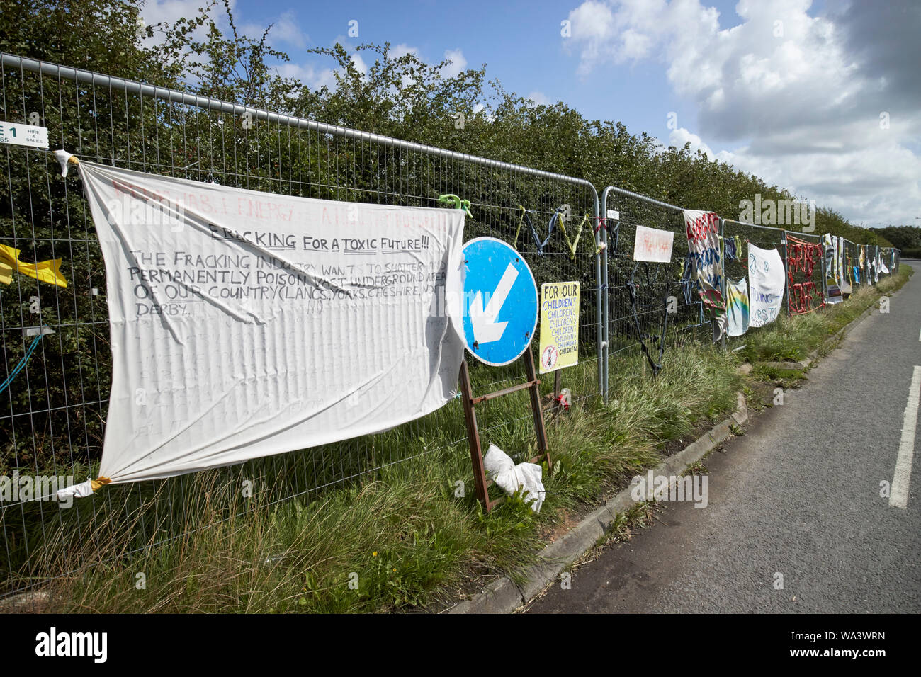protest signs hung on security fencing around the Cuadrilla fracking site at Preston New Road, Little Plumpton, near Blackpool Lancashire England UK Stock Photo