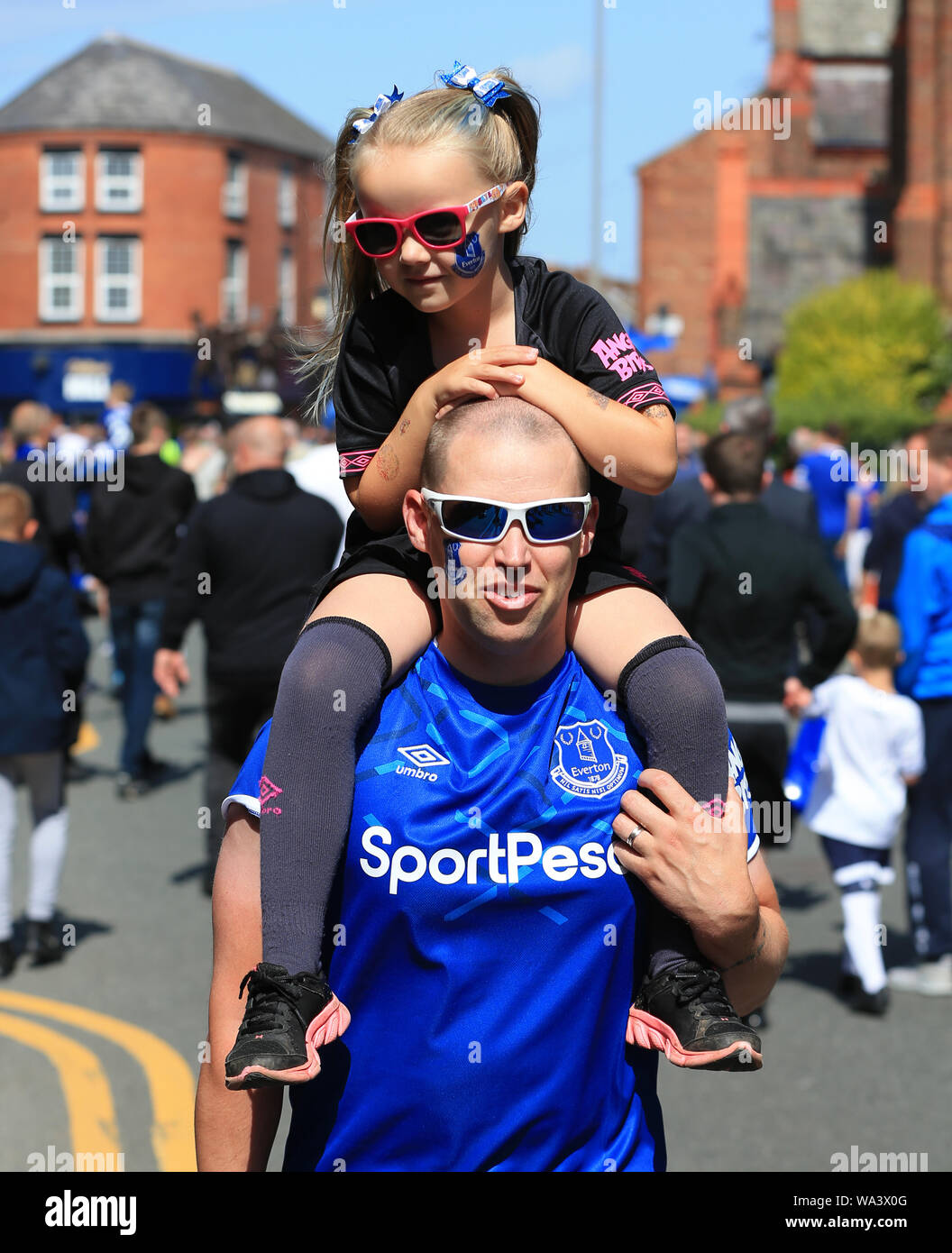 Liverpool, Lancashire, UK. 17th Aug, 2019.  Premier League Football, Everton versus Watford; a young Evertonian with her face painted in club colours rides on her father's shoulders in Goodison Road prior to the match - Editorial Use Only. No use with unauthorized audio, video, data, fixture lists, club/league logos or 'live' services. Online in-match use limited to 120 images, no video emulation. Credit: Action Plus Sports Images/Alamy Live News Stock Photo