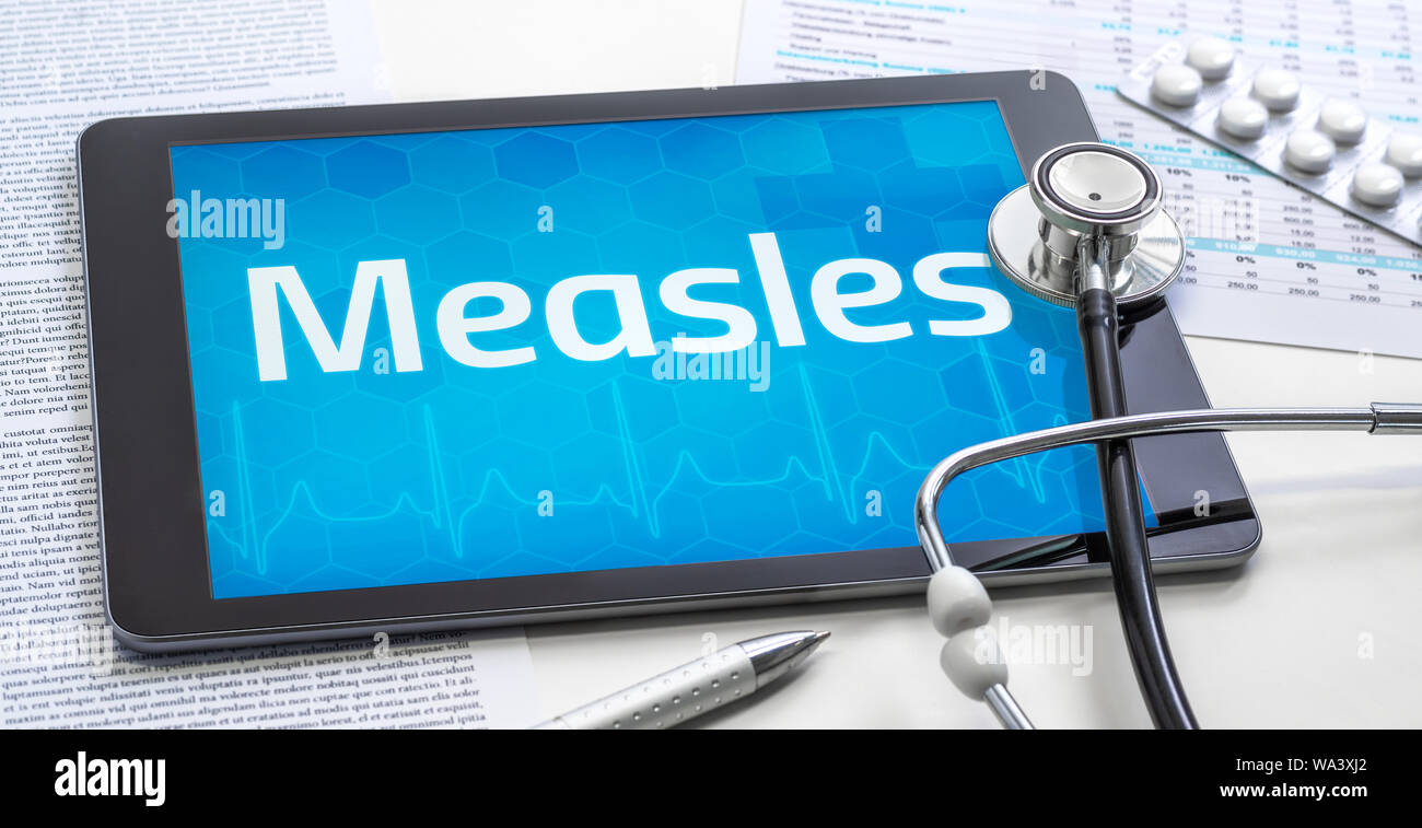 The word Measles on the display of a tablet Stock Photo