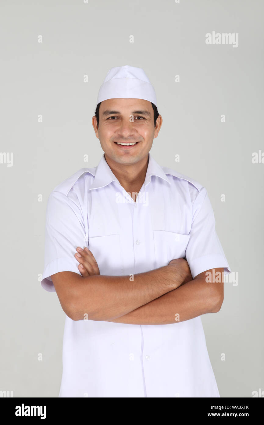 Peon standing with his arms crossed in office Stock Photo - Alamy