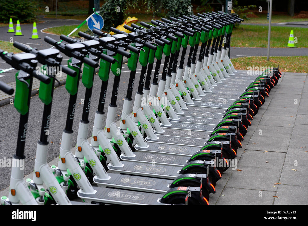 Cologne, Germany. 17th Aug, 2019. E-scooters stand side by side on the  youth traffic square before the start of the E-scooter driving safety  training course. The rental company Lime wants to provide