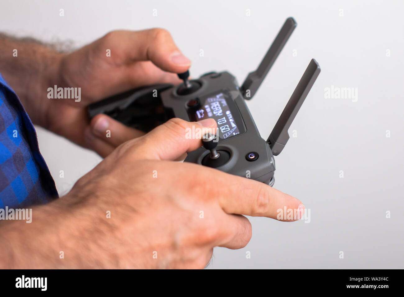 Hands with remote controller of drone outside. Man using RC for flying ...