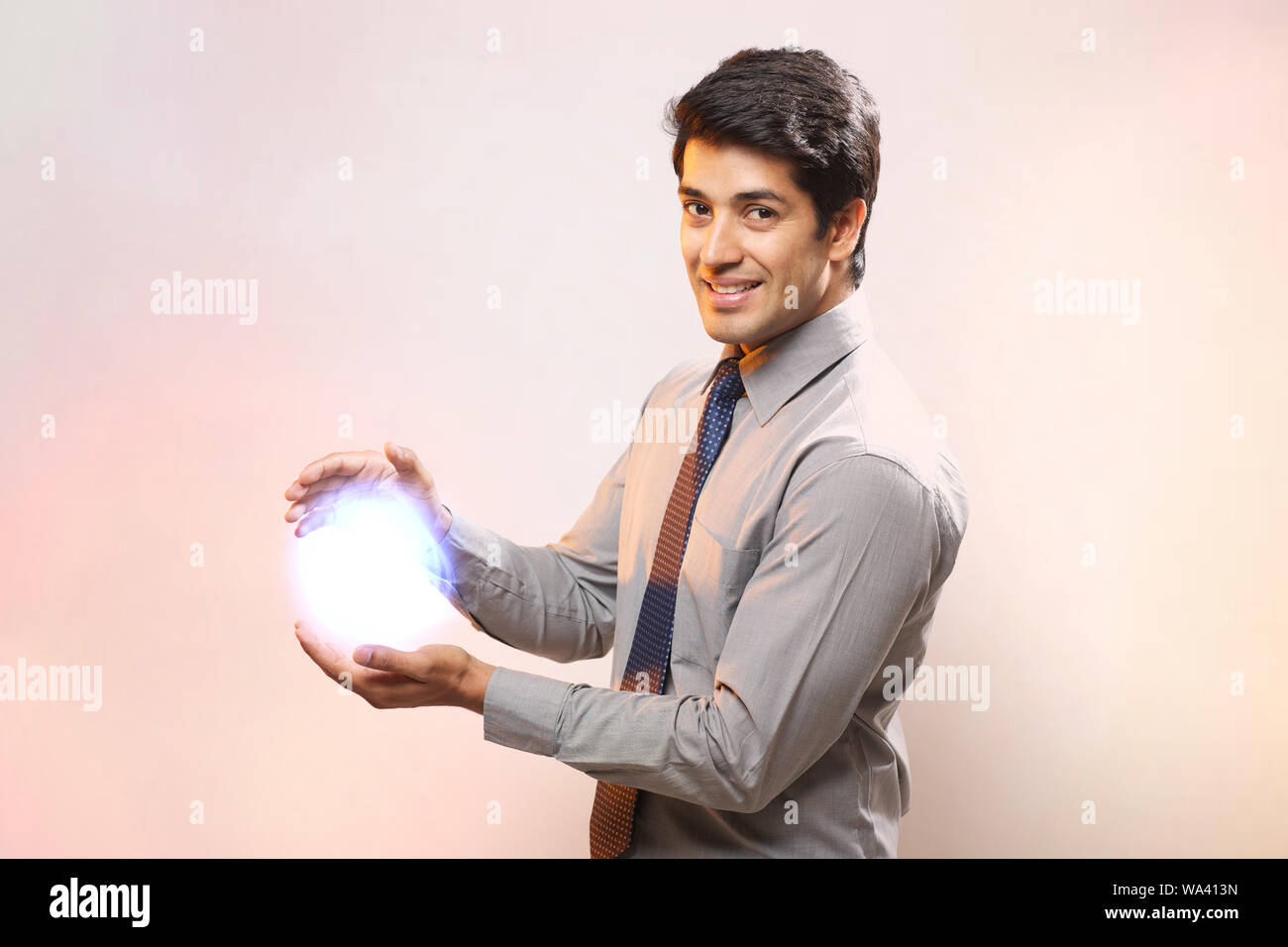 Businessman holding a ball of light Stock Photo Alamy