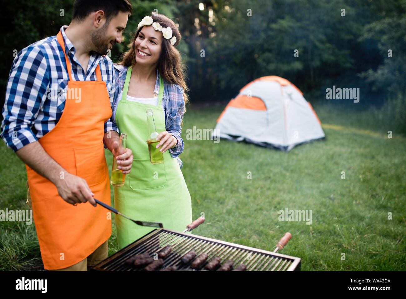 Group of happy friends having barbecue party in forest Stock Photo - Alamy