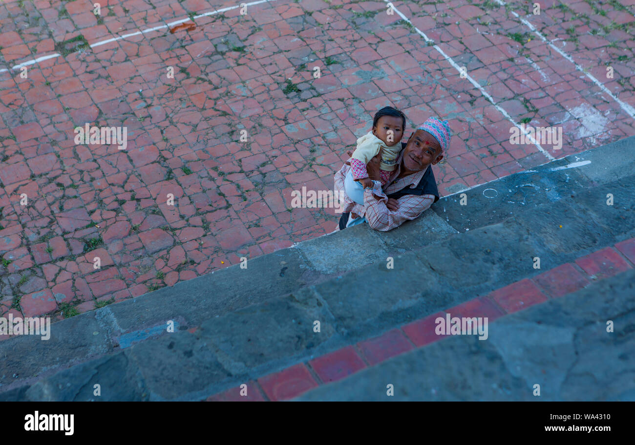 nepalese senior grandfather proudly present a toddler to the camera Stock Photo