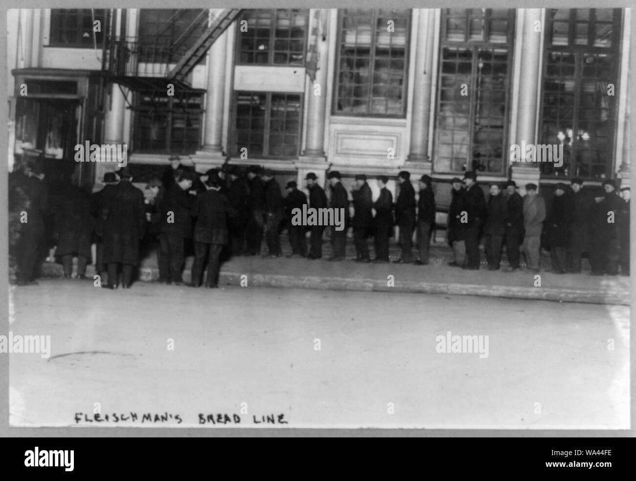Bread lines Bowery men waiting on Fleischman's Bread Line Stock Photo
