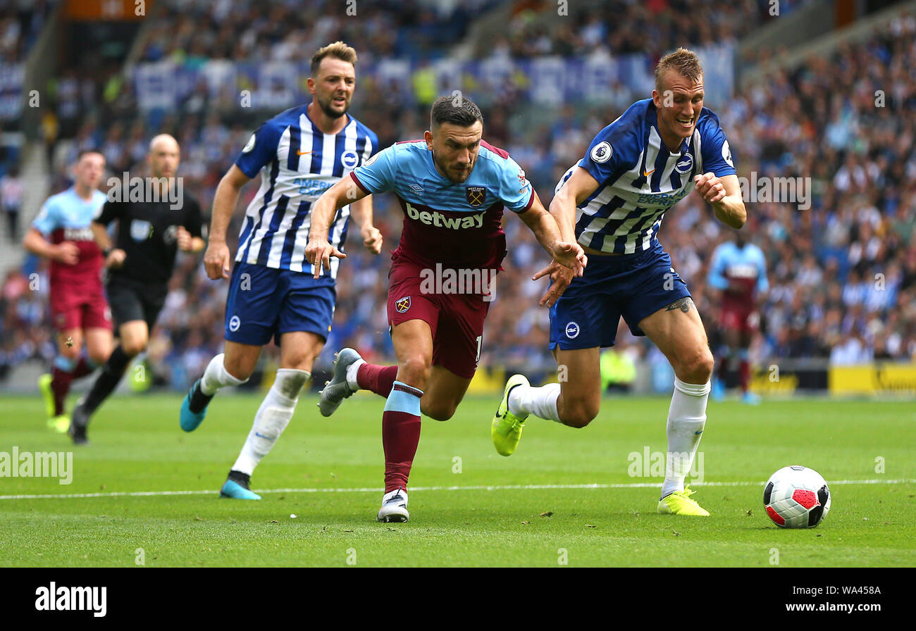 West Ham United's Robert Snodgrass (centre) and Brighton & Hove Albion's Dan Burn (right) battle for the ball during the Premier League match at The AMEX Stadium, Brighton. Stock Photo