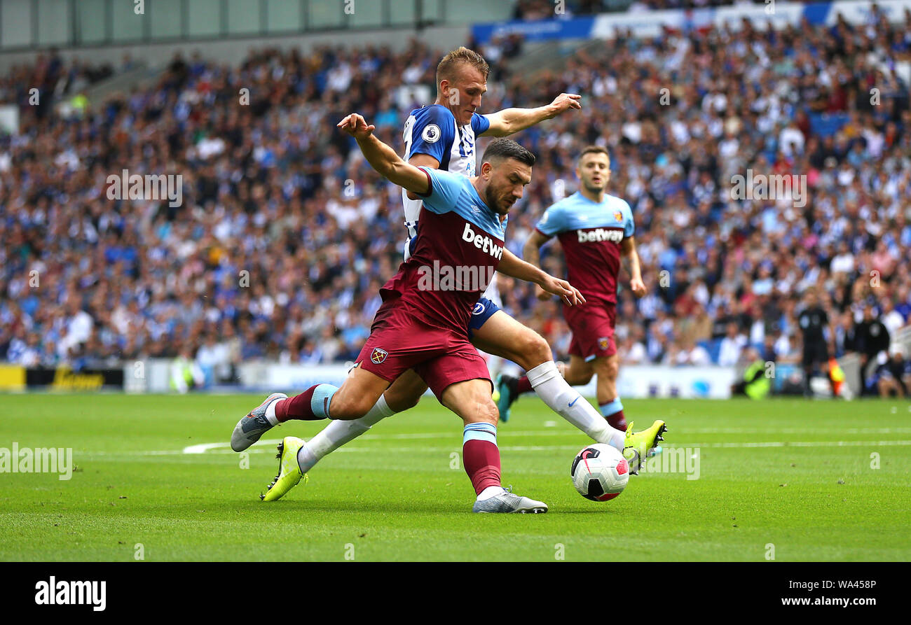 West Ham United's Robert Snodgrass (left) and Brighton & Hove Albion's Dan Burn (right) battle for the ball during the Premier League match at The AMEX Stadium, Brighton. Stock Photo