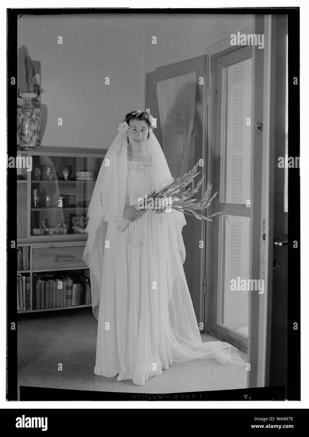 Bride in bridal gown holding flowers, Dawkins Anderson wedding Stock Photo