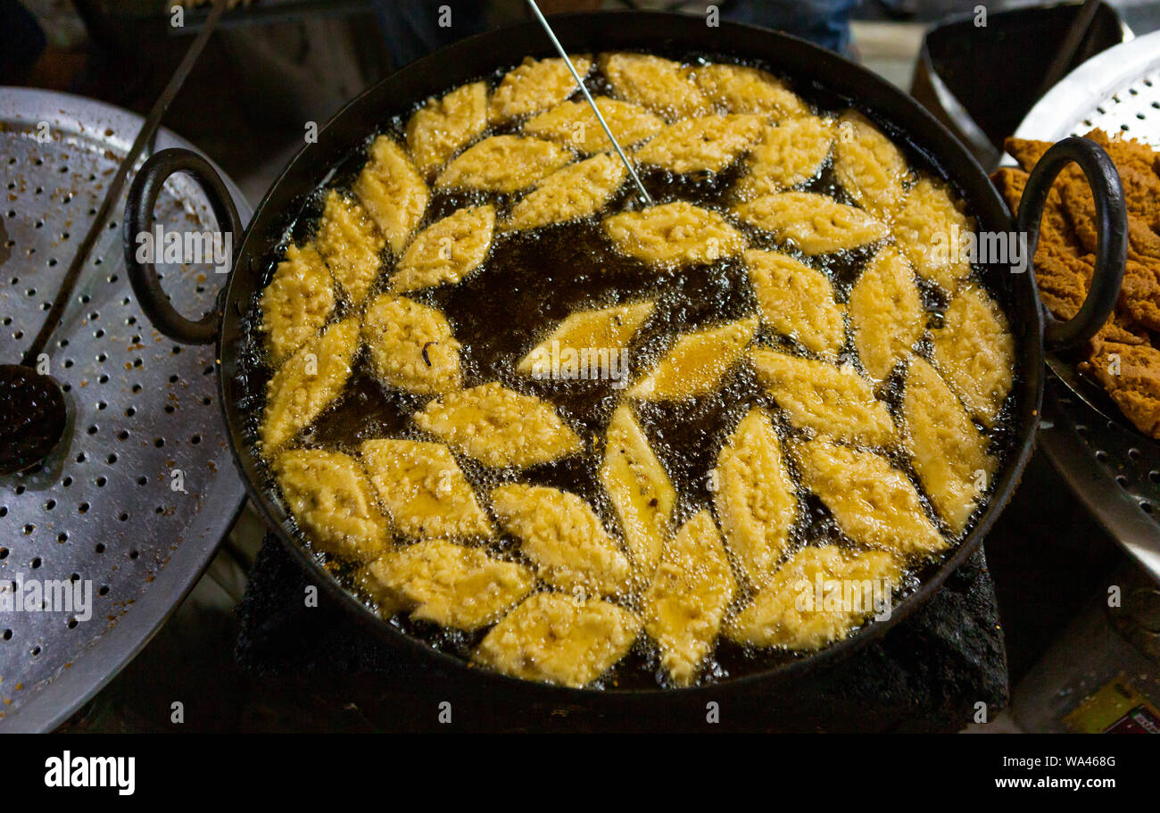 deep fried sweets cooked in an iron pan in Asia Stock Photo