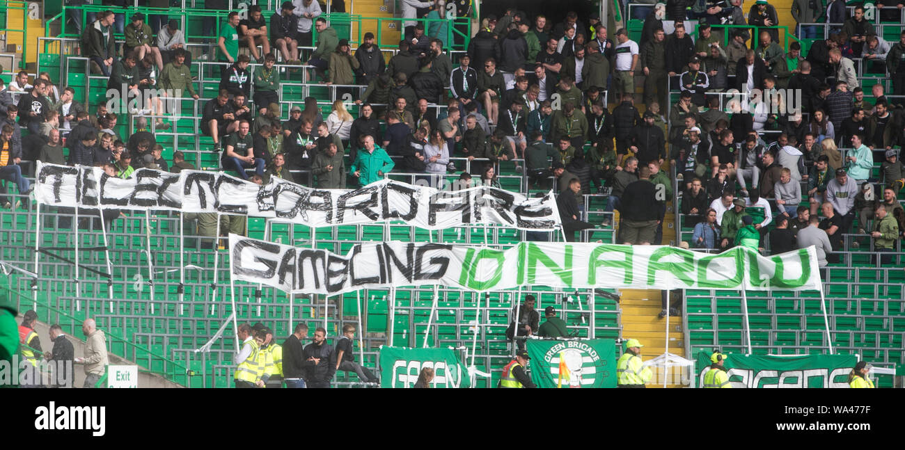 Fans hold up banners during the Betfred Cup second round match at ...