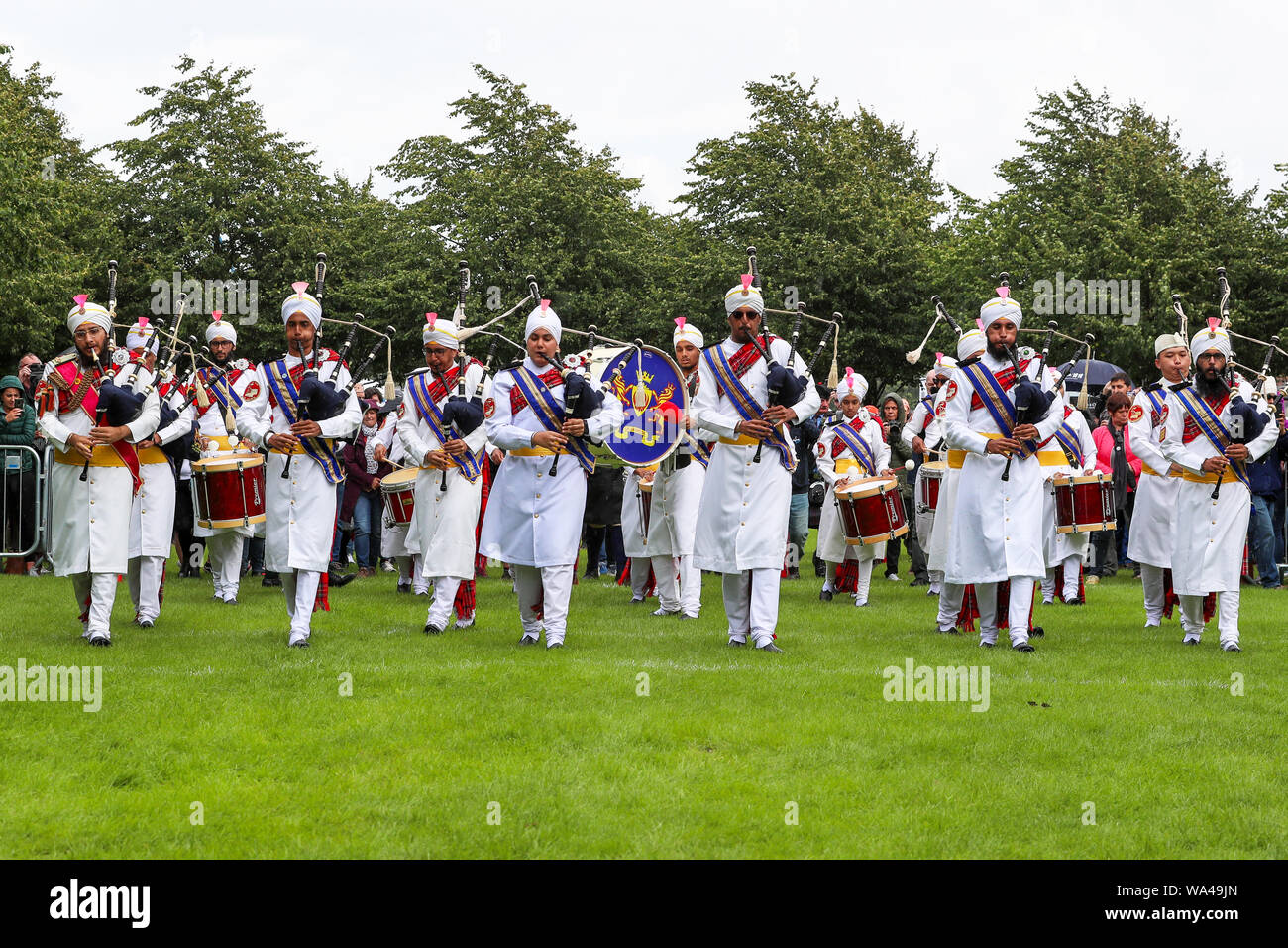 Glasgow, UK. 17th Aug 2019. The very popular and colourful Sri Dasmesh Pipe band from Malaysia had just completed their performances at the World Pipe band Championships at Glasgow Green, Glasgow, Scotland, UK Credit: Findlay/Alamy Live News Stock Photo