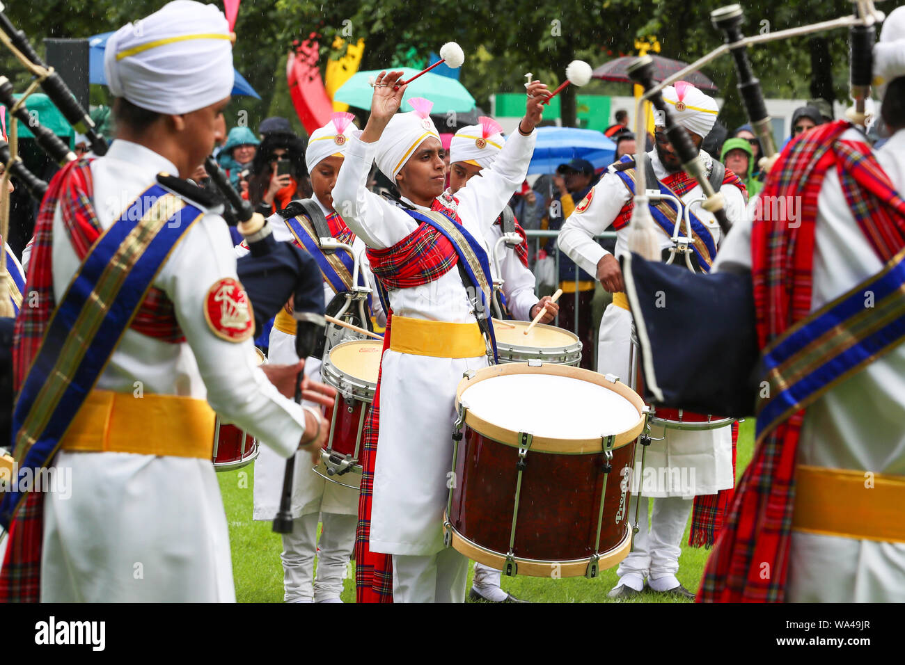 Glasgow, UK. 17th Aug 2019. The very popular and colourful Sri Dasmesh Pipe band from Malaysia had just completed their performances at the World Pipe band Championships at Glasgow Green, Glasgow, Scotland, UK Credit: Findlay/Alamy Live News Stock Photo