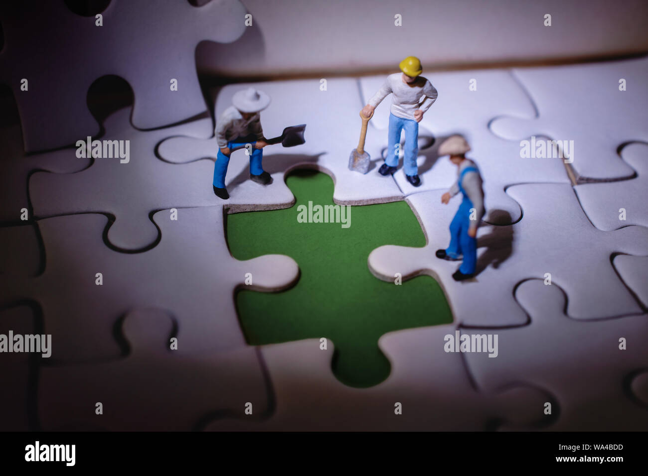 Teamwork and Solving Problem Concept. Group of Miniature Worker Men Found  Something Wrong on the Work Process (a Piece of Jigsaw Puzzle Stock Photo -  Alamy