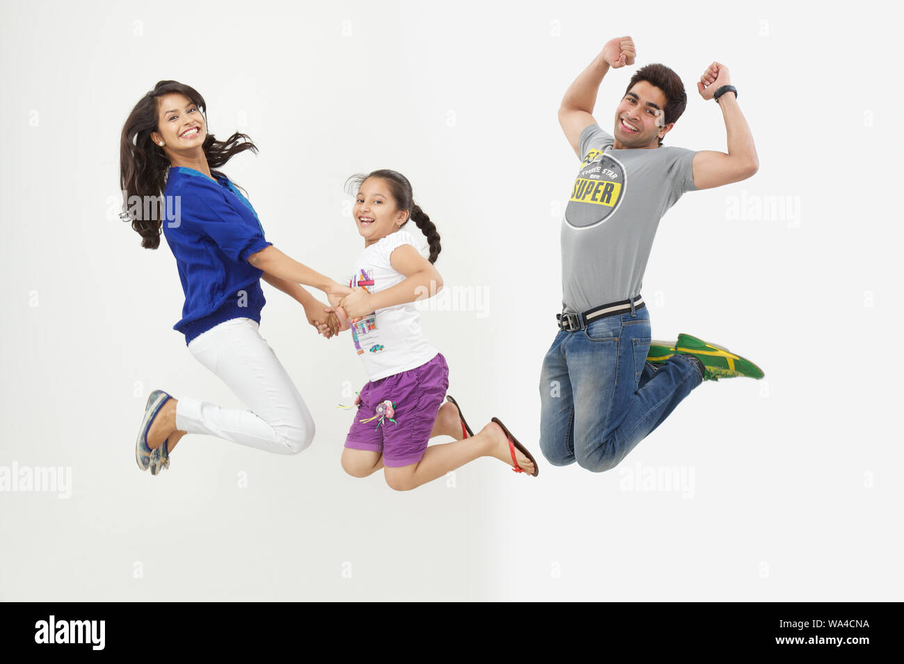 Girls holding hands jumping hi-res stock photography and images - Alamy
