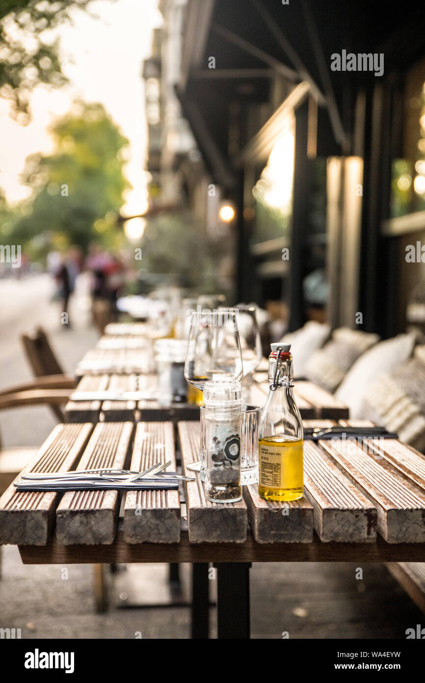 Cafe outdoor table setting with glasses and condimentsCafe outdoor table setting with glasses and condiments Stock Photo
