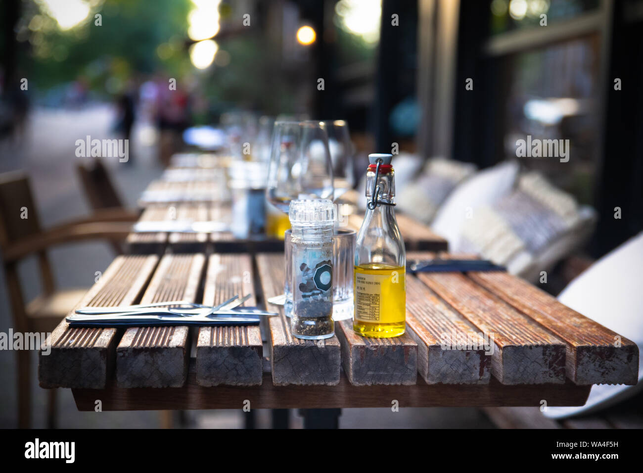 Cafe outdoor table setting with glasses and condimentsCafe outdoor table setting with glasses and condiments Stock Photo