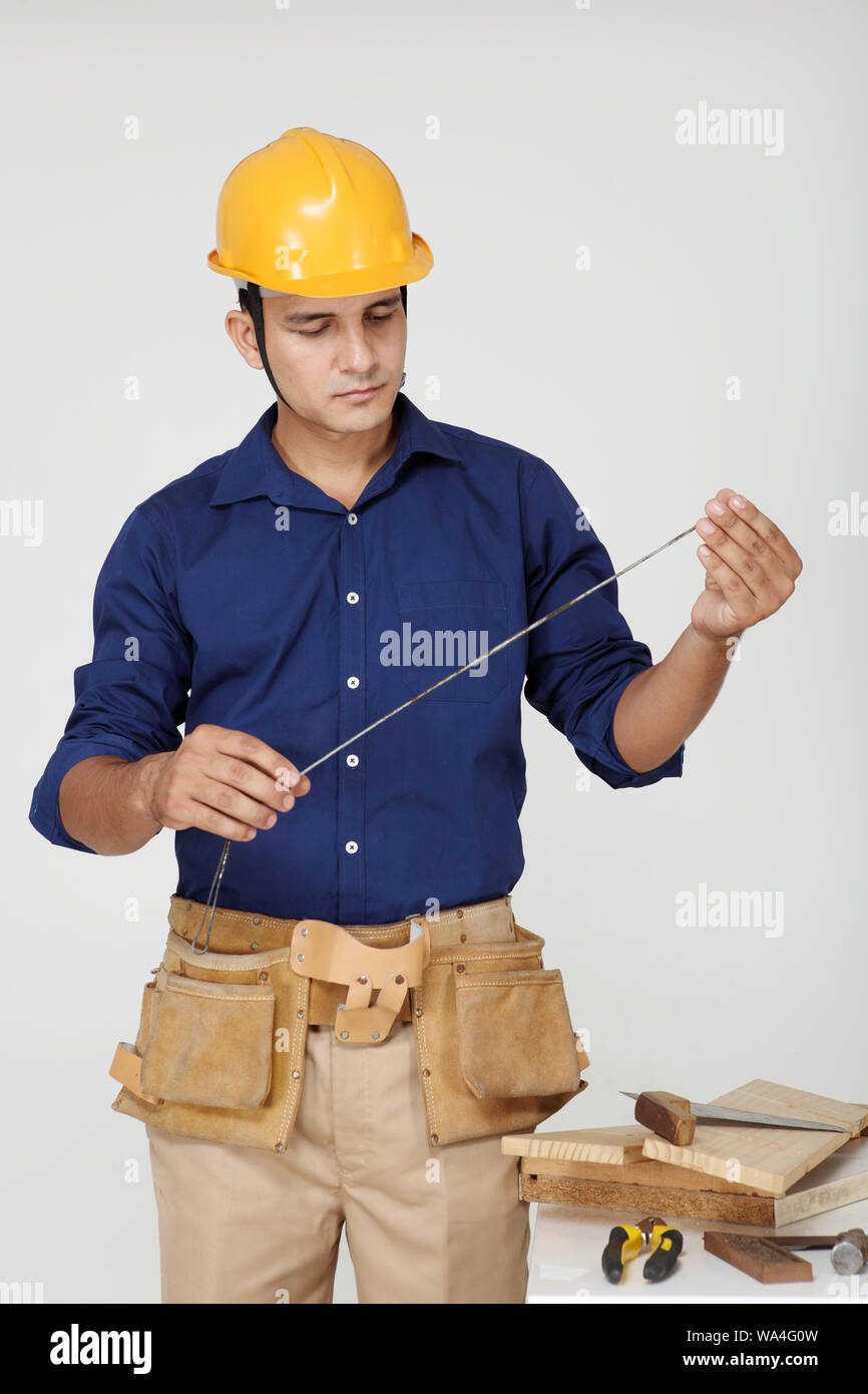 Carpenter with measuring tape Stock Photo Alamy