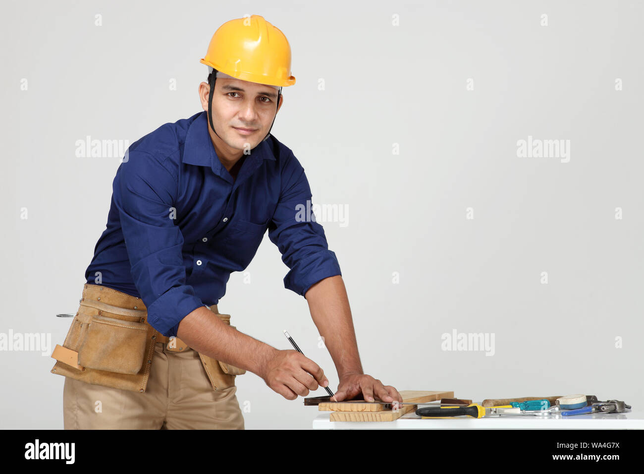 Carpenter measuring with ruler Stock Photo